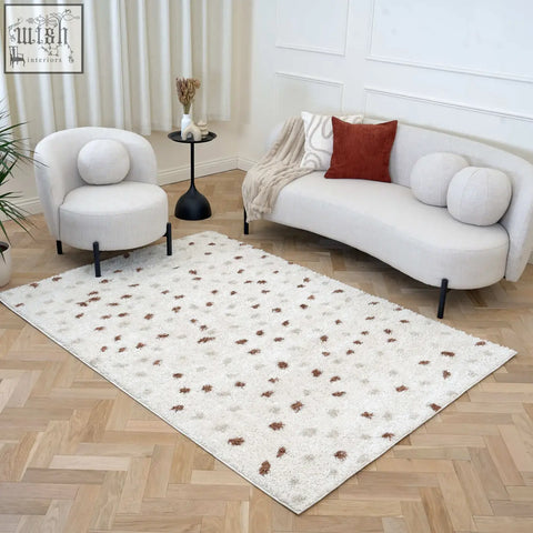 A cream-colored moodi shaggy cream area rug with shaggy cream terra texture and brown gray floral motifs