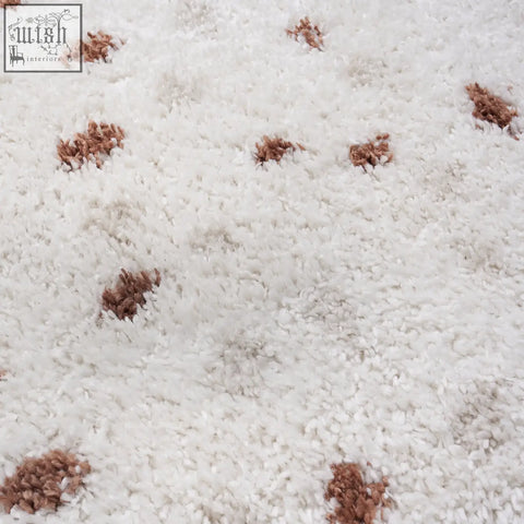 White plush moodi shaggy cream rug with scattered brown textured tufts shaggy cream terra design