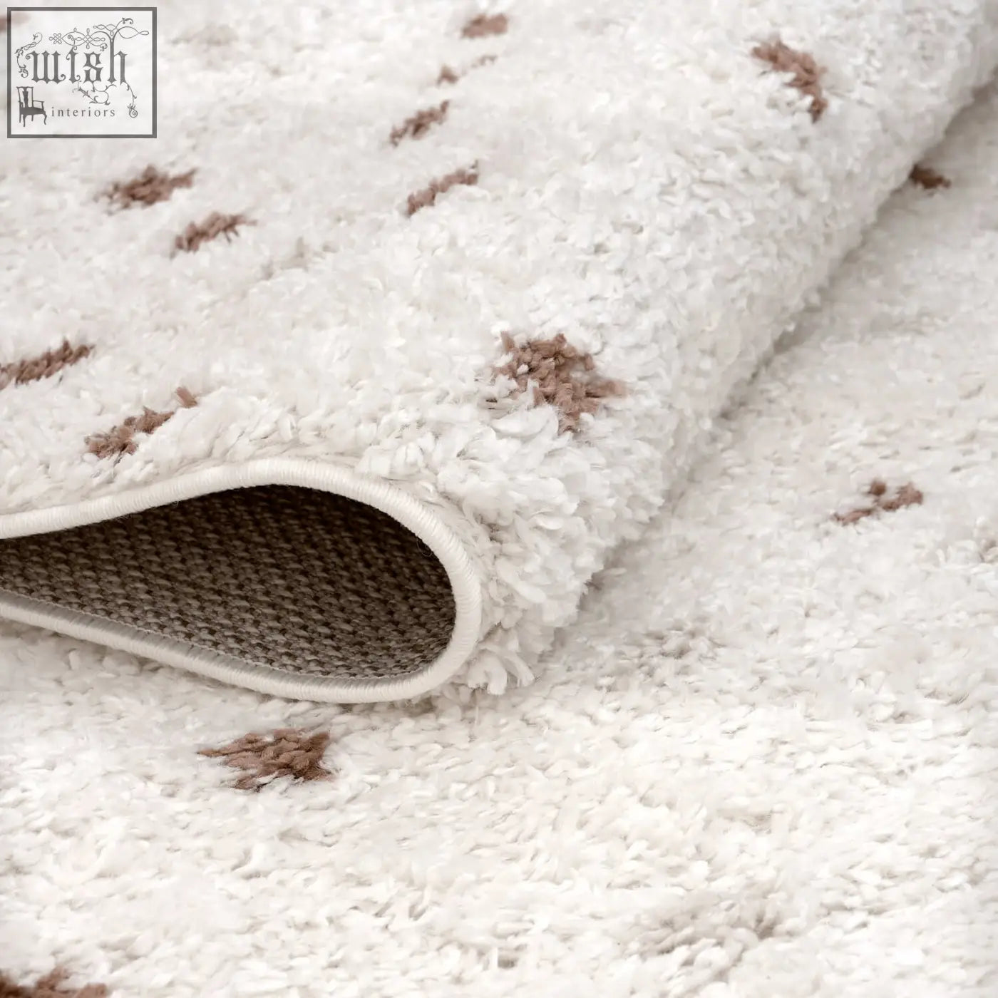 White plush moodi shaggy cream rug with brown tufted accents and woven backing for cozy living spaces