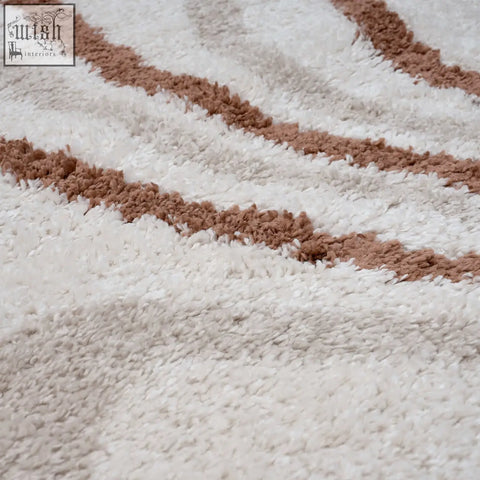 Creamy moodi shaggy cream rug with soft textured loops and wavy brown stripes perfect for cozy spaces