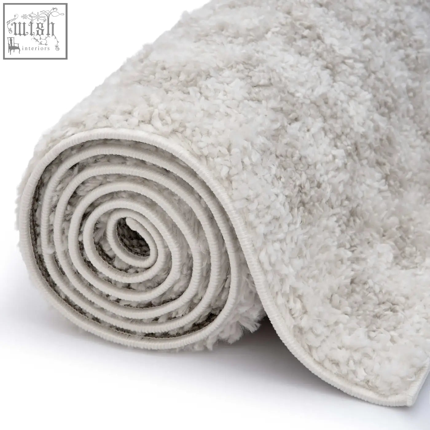 A plush moodi shaggy light beige nomari rug rolled into a tight spiral showcasing its soft shaggy texture