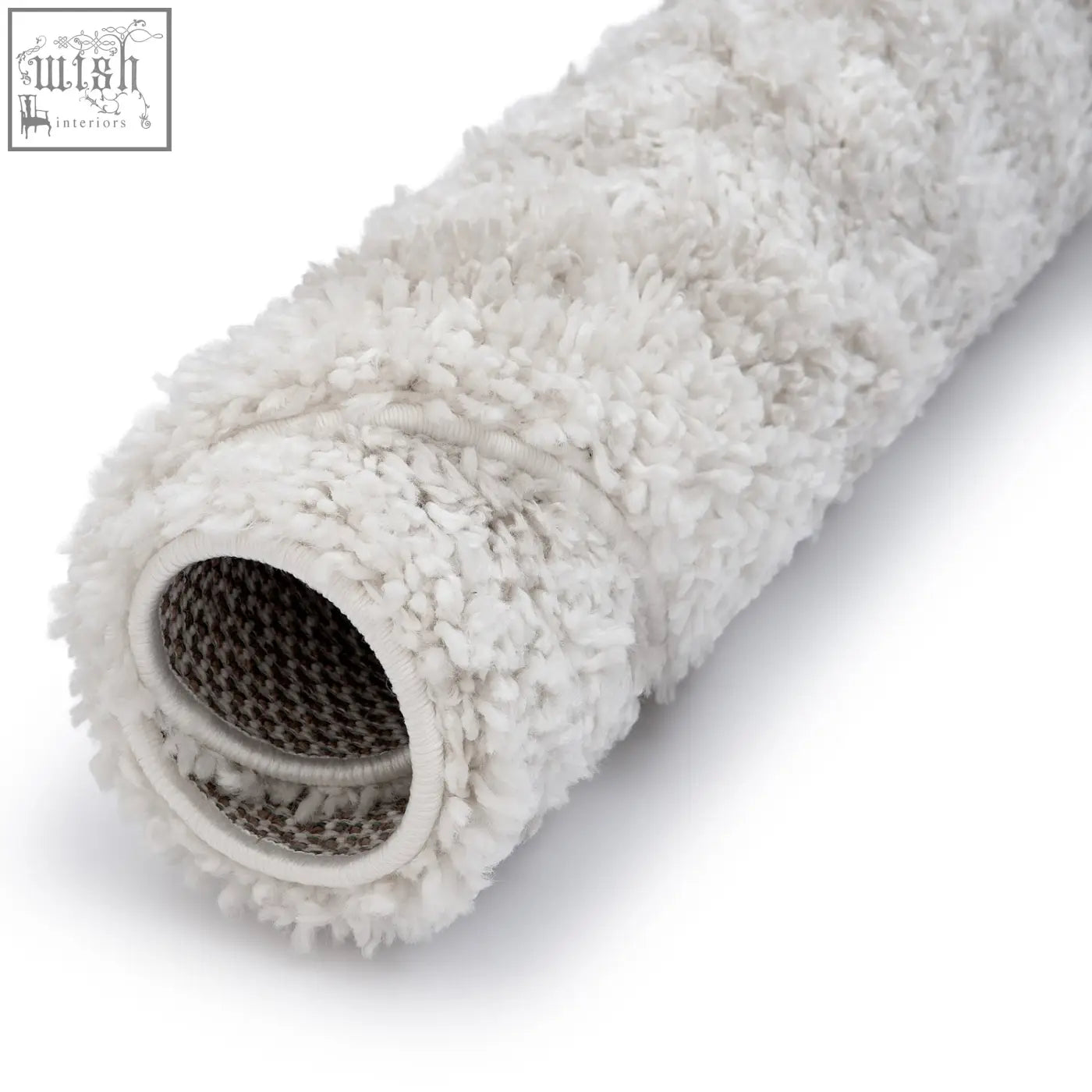 White fluffy microfiber paint roller with textured surface and mesh interior shown with moodi shaggy light beige rug