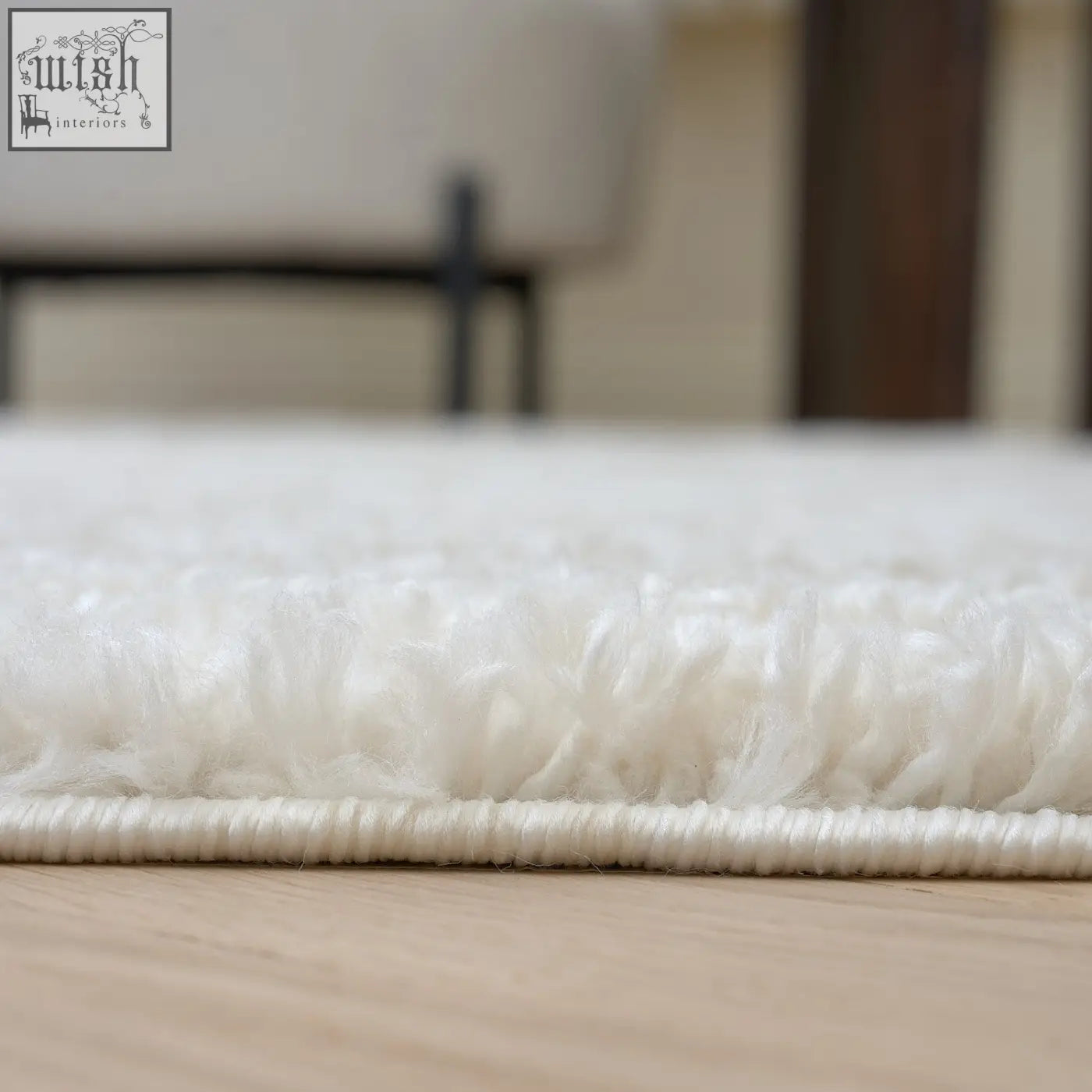 White plush shag rug with soft fluffy texture and neatly stitched border in light beige moodi shaggy light design
