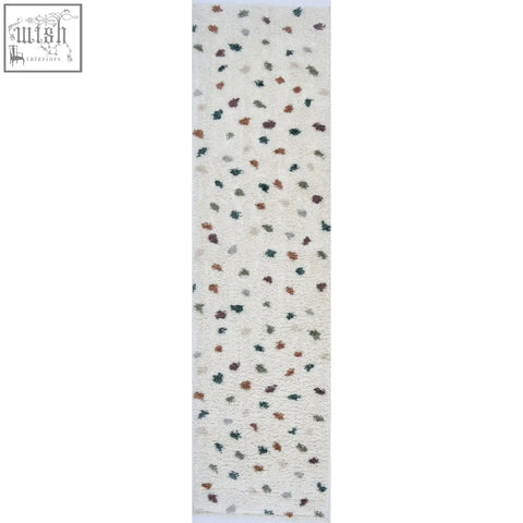 A plush off-white moodi shaggy multicolour jubile rug with textured leaf motifs in muted earth tones