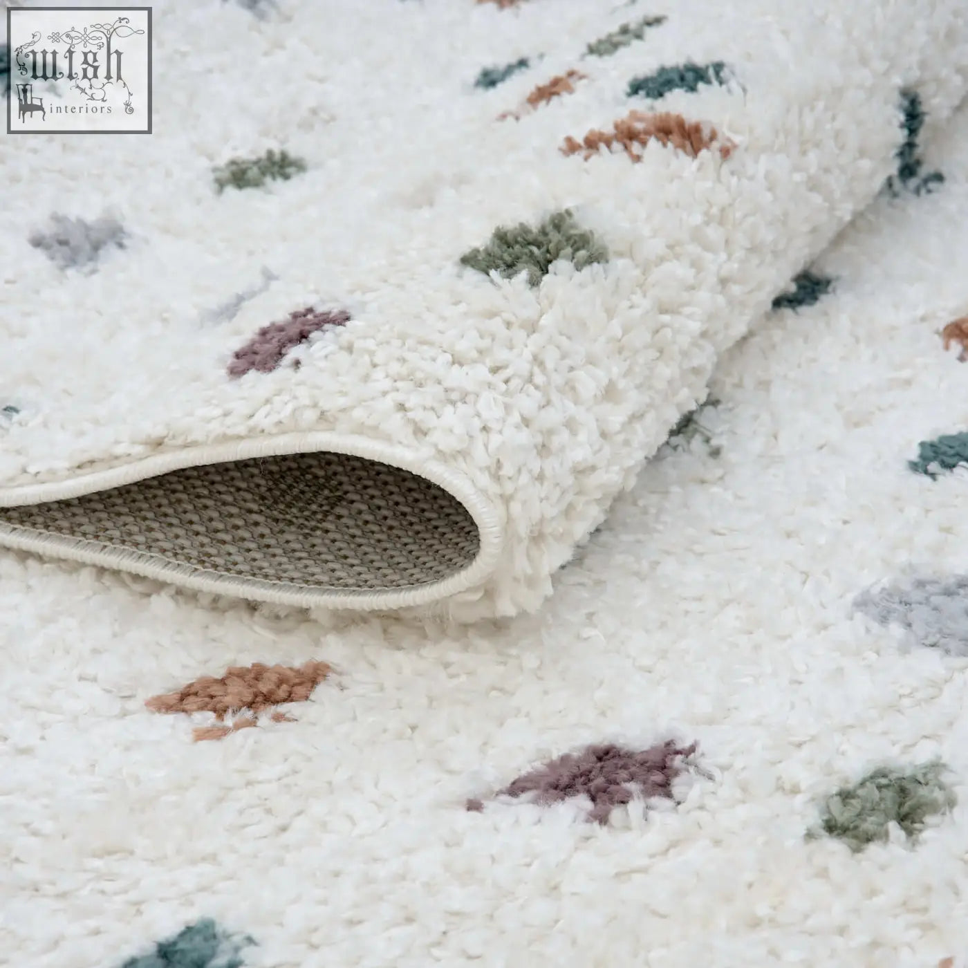 A plush white moodi shaggy multicolour rug with soft shaggy texture and patches of green dusty rose and gray