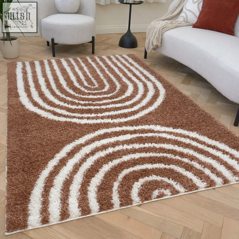 A plush brown and white moodi shaggy terra rug with a modern swirling pattern perfect for cozy spaces