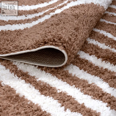 A plush moodi shaggy terra tawny rug with brown and white stripes and a soft shaggy texture perfect for bathrooms