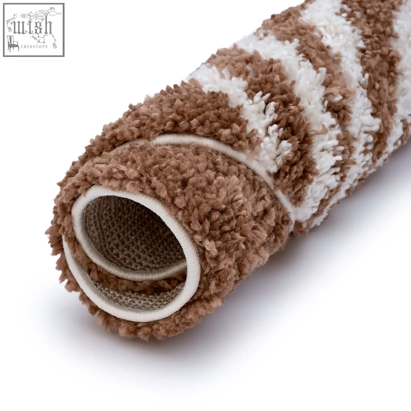 A plush cylindrical moodi shaggy terra bath mat with soft brown and white striped shaggy terra tawny rug fabric