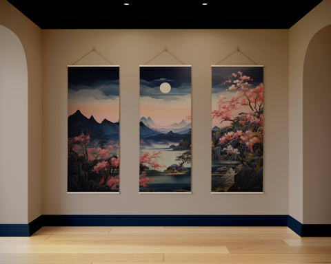 Three vertical white-framed scroll tapestries depicting serene night cherry blossom mountain landscapes with full moon