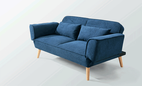 Morales foldable sofa bed in navy blue fabric with wooden legs and two matching throw pillows for kids