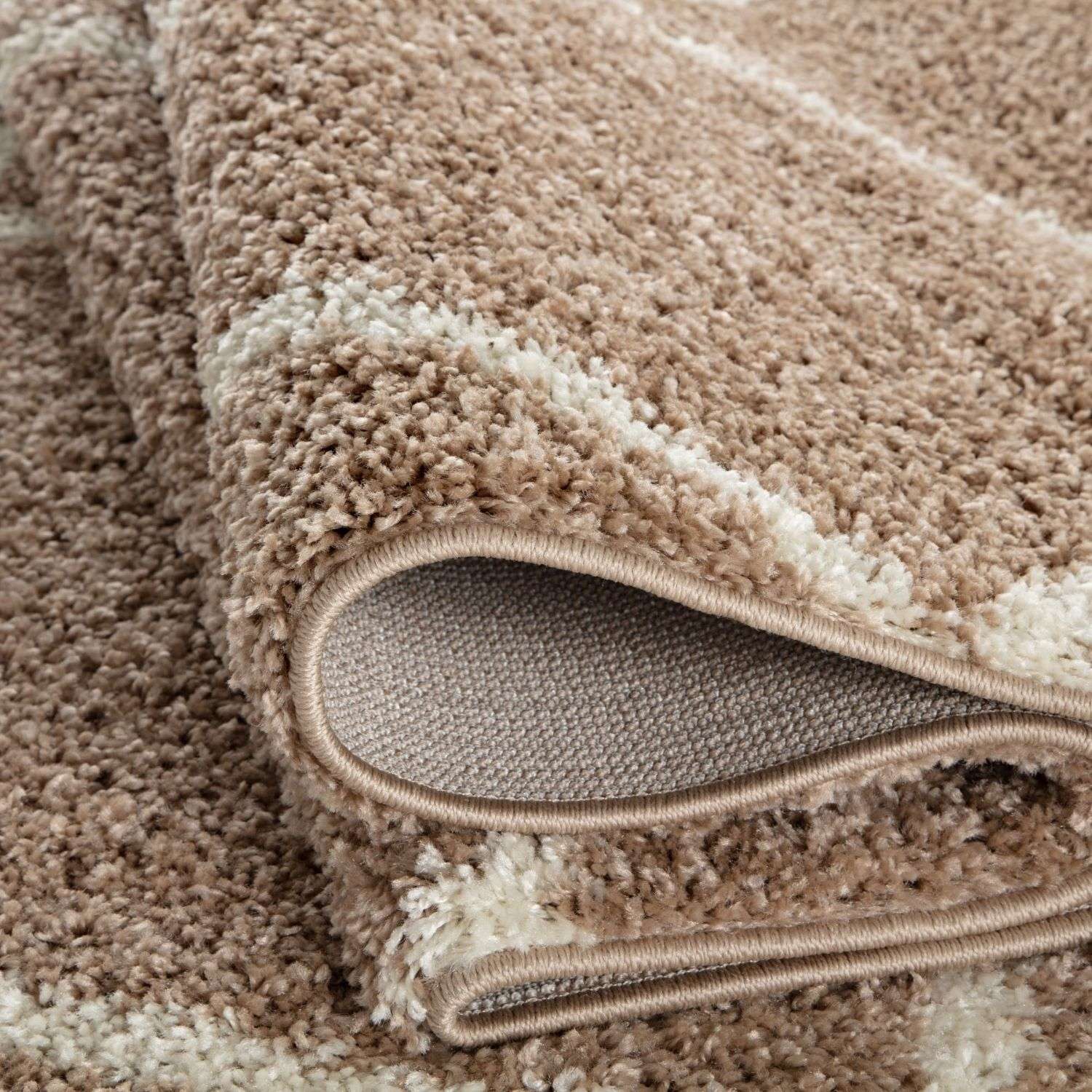 Moroccan beige shaggy bath rug with beige and cream stripes and a plush textured surface perfect for bathrooms