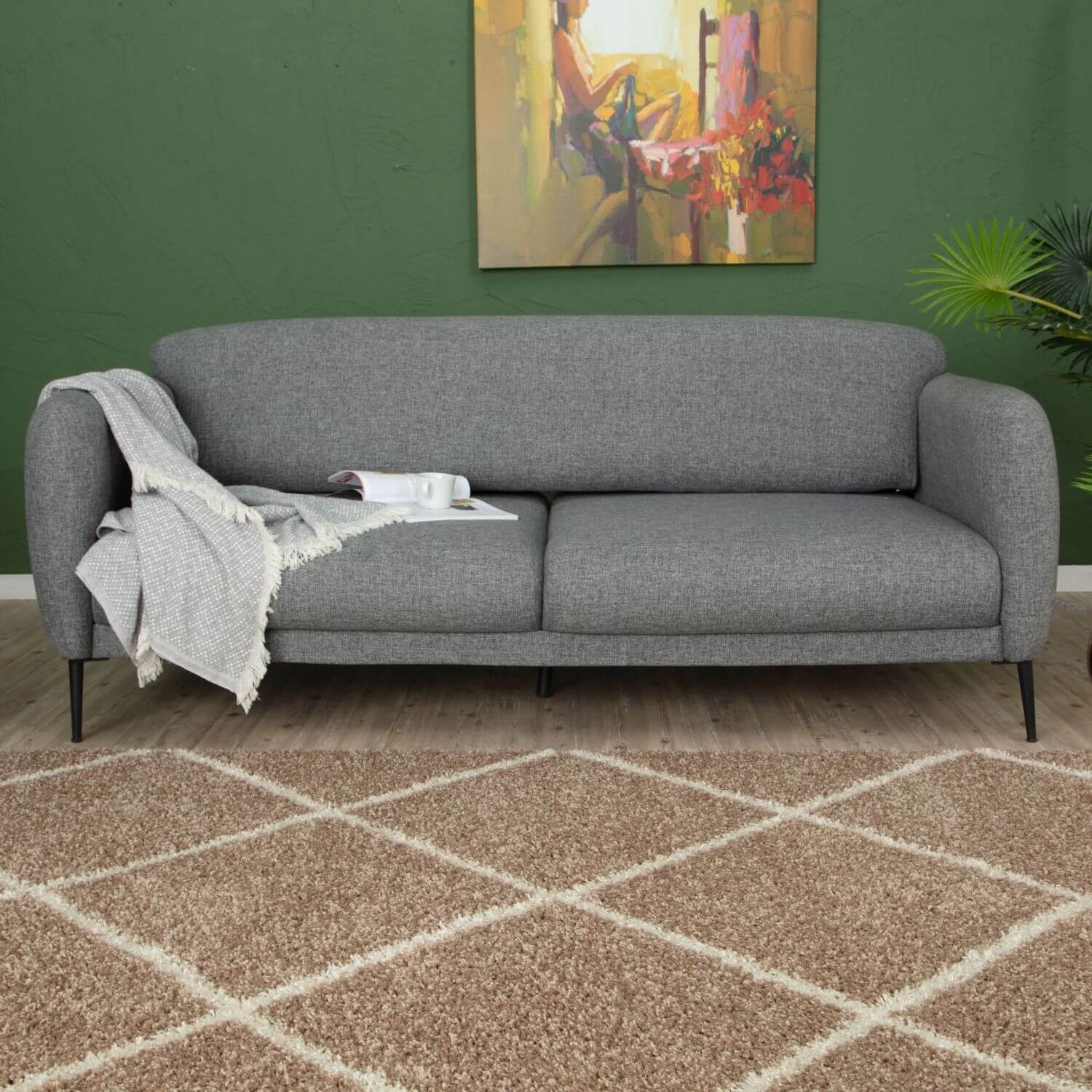 Gray textured fabric sofa with black legs and light gray throw on moroccan beige shaggy rug 520