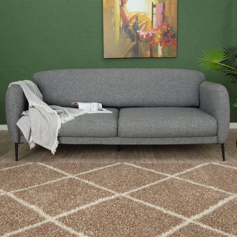 Gray textured fabric sofa with black legs and light gray throw on moroccan beige shaggy rug 520