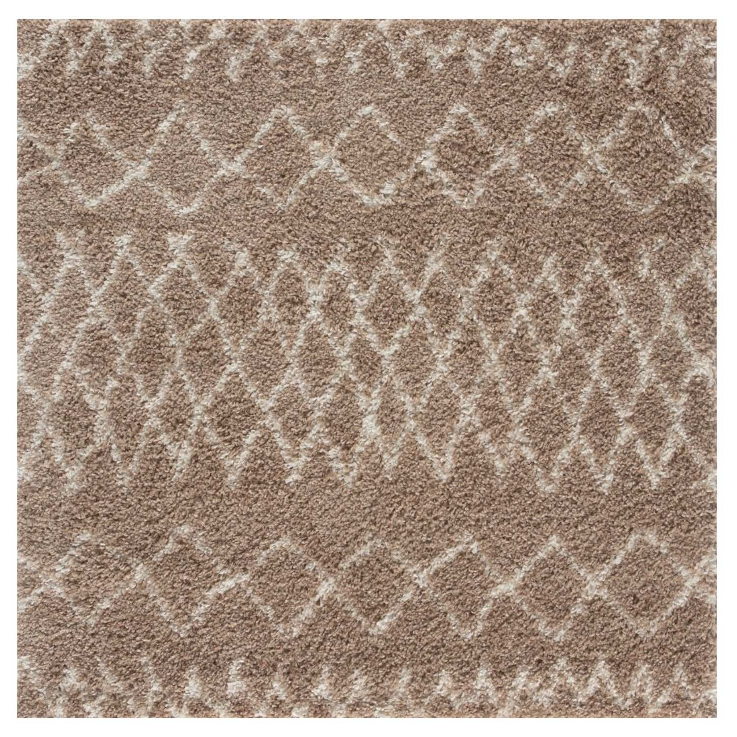 A plush moroccan beige shaggy rug with a soft textured surface and intricate lighter beige geometric pattern