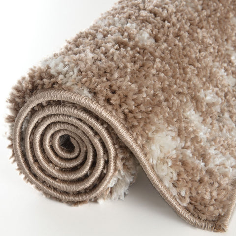 A plush moroccan beige shaggy rug rolled neatly showing soft beige and white shaggy texture on a clean surface
