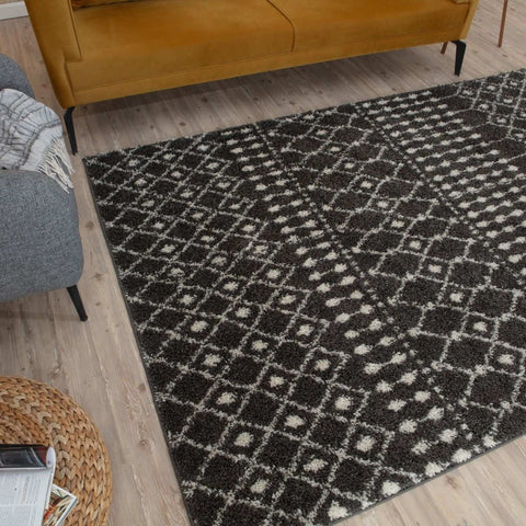 Black and white geometric patterned moroccan dark grey shaggy rug with soft plush texture and modern design