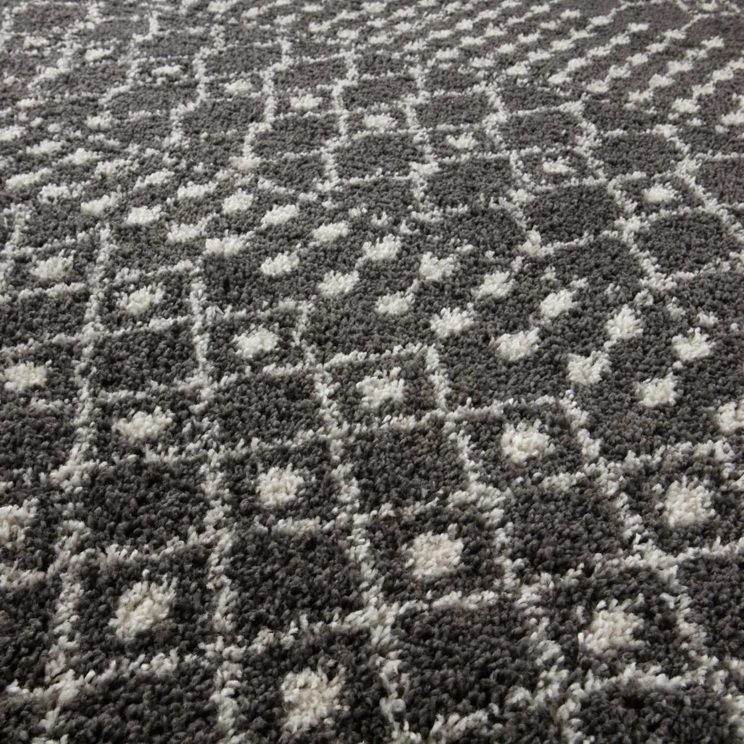 Moroccan dark grey shaggy rug with gray and white geometric pattern and a plush textured surface