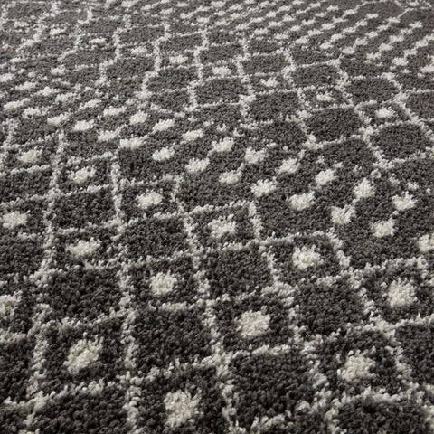 Moroccan dark grey shaggy rug with gray and white geometric pattern and a plush textured surface