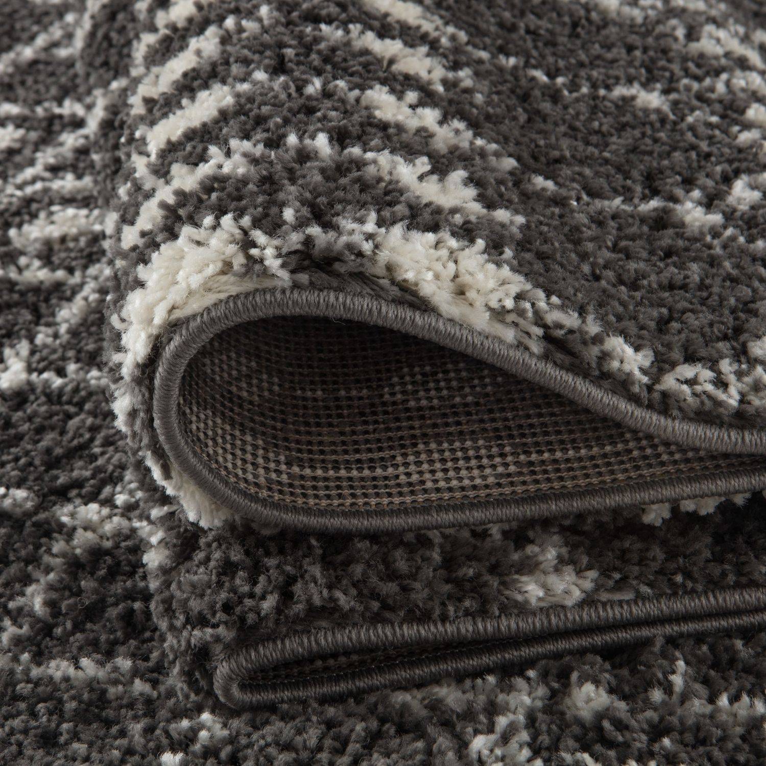 A plush moroccan dark grey shaggy rug with soft grey and cream striped pattern perfect for cozy spaces