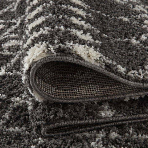 A plush moroccan dark grey shaggy rug with soft grey and cream striped pattern perfect for cozy spaces