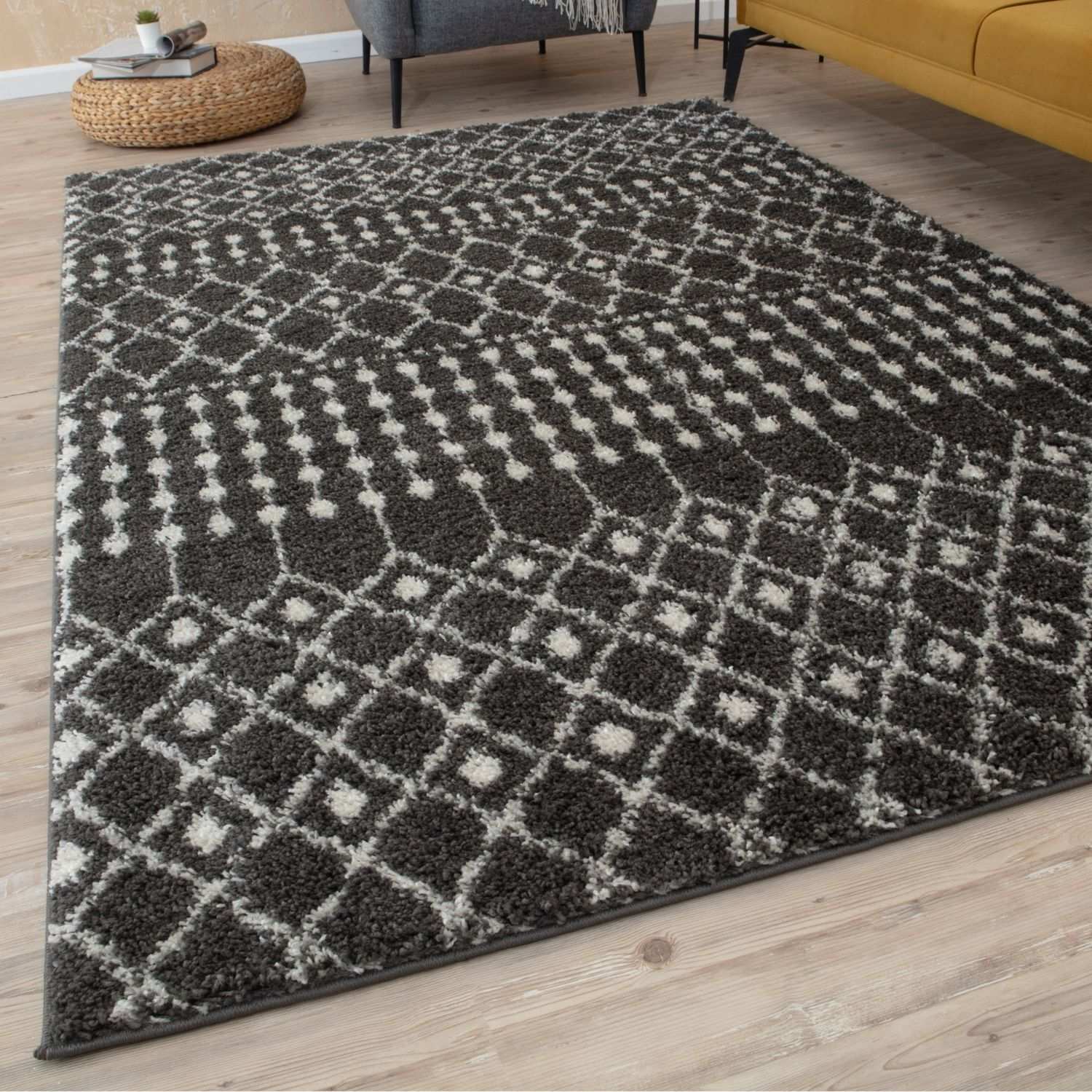 A plush moroccan dark grey shaggy rug with a geometric pattern in grey and white perfect for cozy spaces