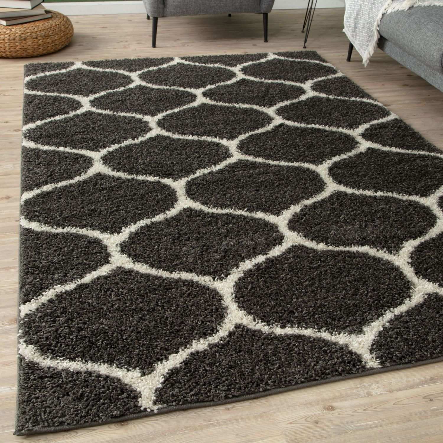 A plush moroccan dark grey shaggy rug with cream geometric pattern perfect for cozy living spaces