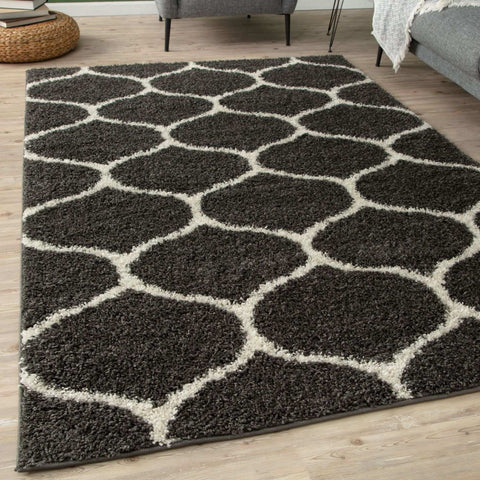 A plush moroccan dark grey shaggy rug with cream geometric pattern perfect for cozy living spaces