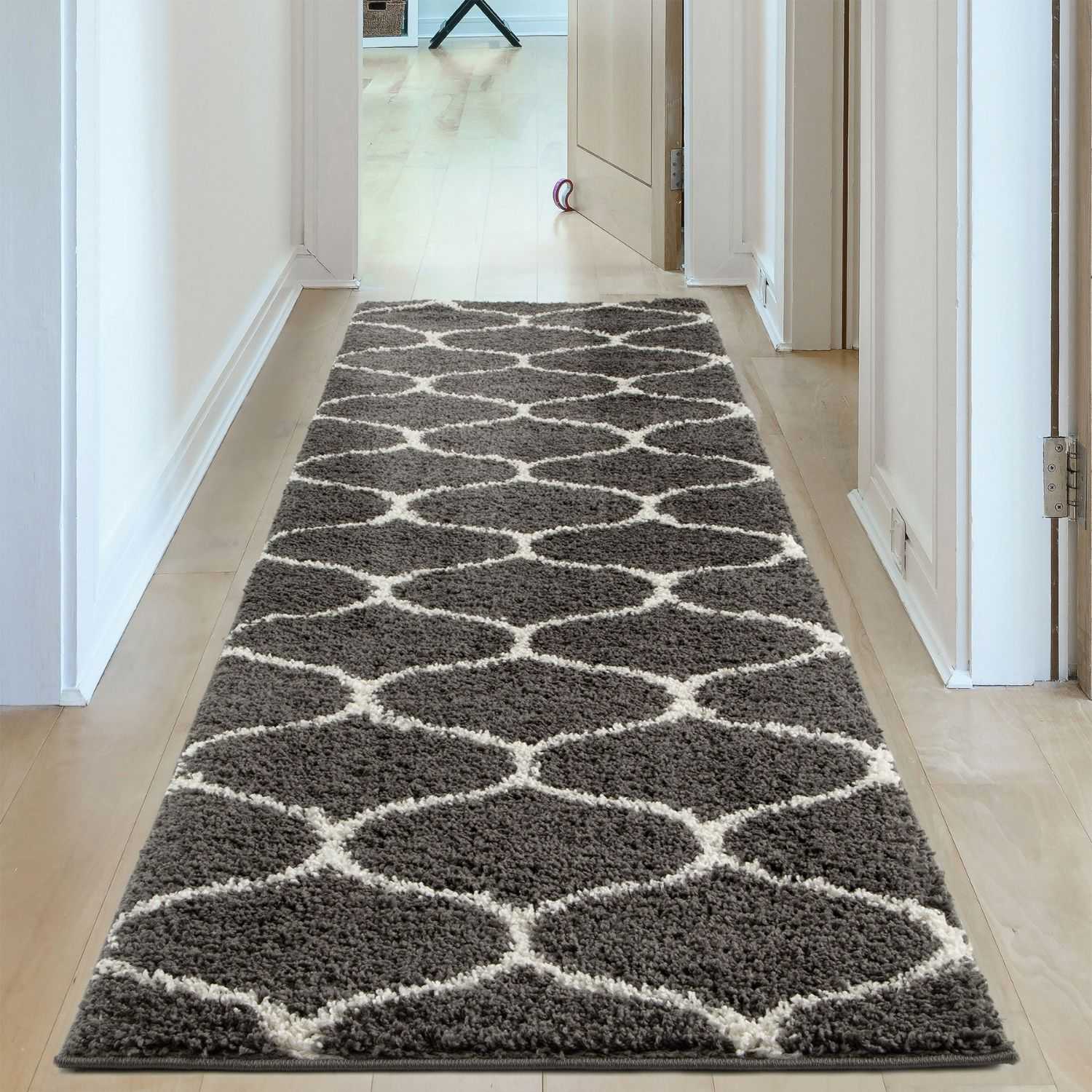 A moroccan dark grey shaggy rug with a plush gray and cream geometric pattern perfect for hallways