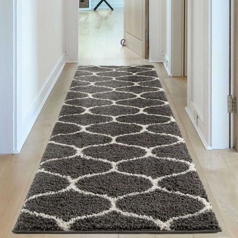A moroccan dark grey shaggy rug with a plush gray and cream geometric pattern perfect for hallways