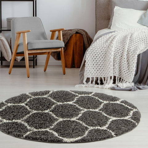 A plush moroccan dark grey shaggy round rug with a gray and white geometric pattern for cozy spaces