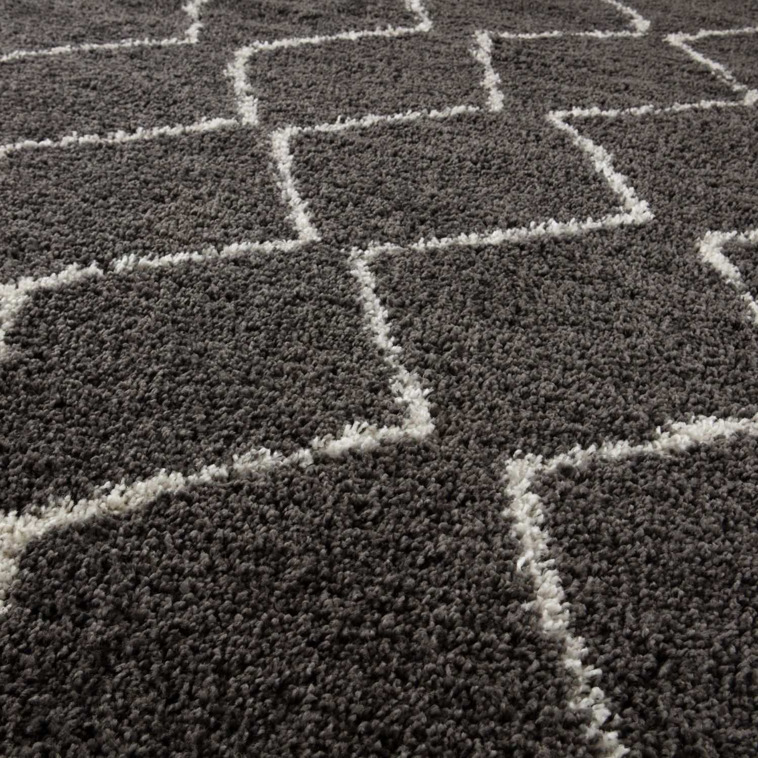 Moroccan dark grey shaggy rug with a geometric pattern of white fluffy lines forming interconnected squares