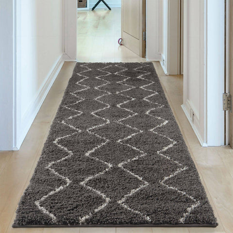 A plush moroccan dark grey shaggy runner rug with an off-white geometric diamond pattern for cozy decor