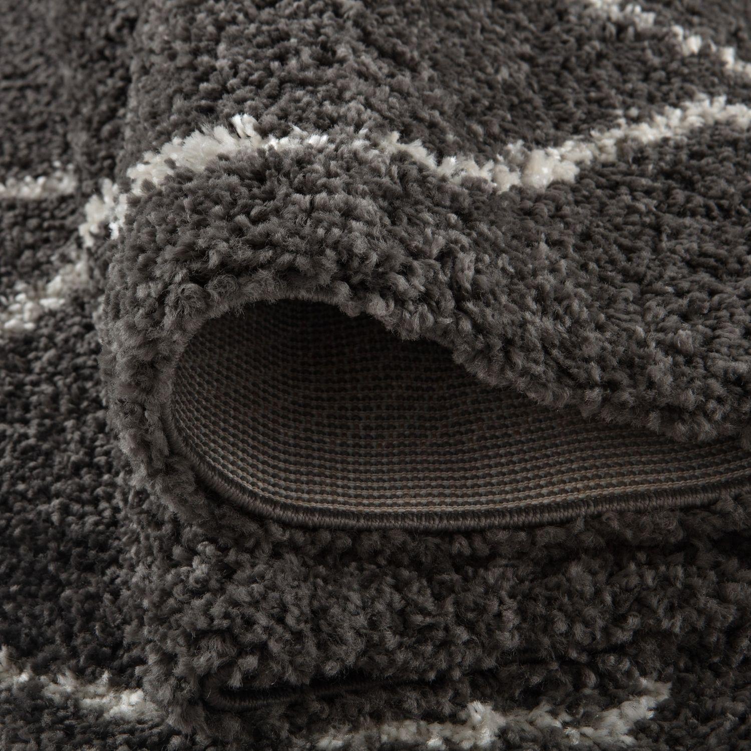 A plush moroccan dark grey shaggy rug with soft textured surface in dark grey and white stripes
