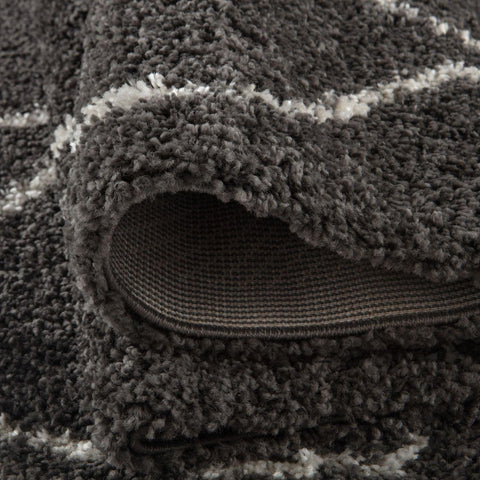 A plush moroccan dark grey shaggy rug with soft textured surface in dark grey and white stripes