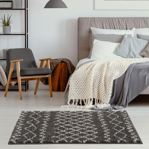 Moroccan dark grey shaggy rug with a plush textured surface and geometric grey and white pattern