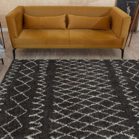 A plush moroccan dark grey shaggy rug with a black and white geometric pattern perfect for cozy spaces