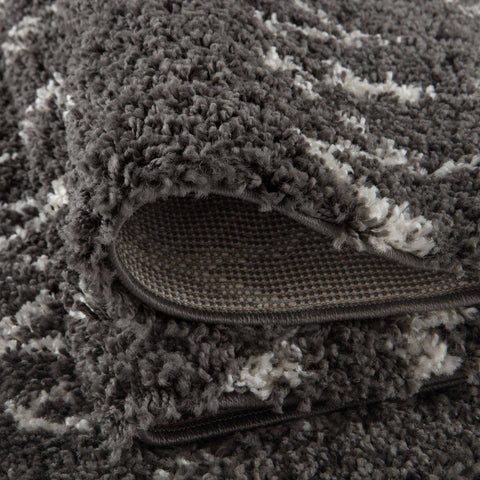 A plush moroccan dark grey shaggy rug with a textured grey and white pattern perfect for cozy spaces