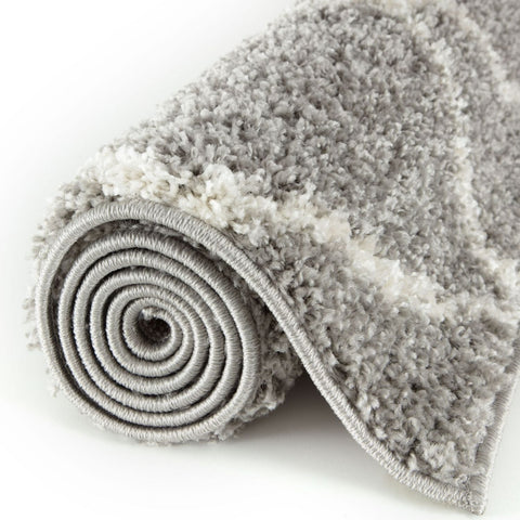 A plush moroccan grey shaggy rug with rolled edges and a soft textured surface perfect for cozy spaces