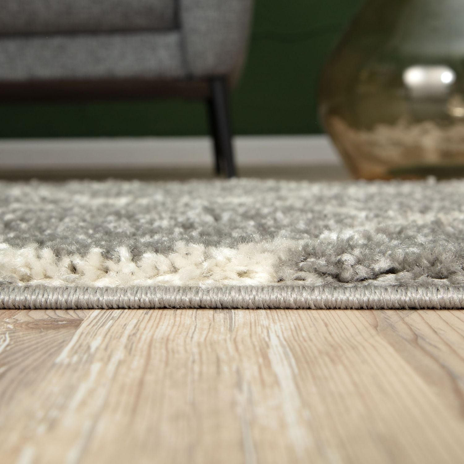 A plush moroccan grey shaggy rug with two-toned gray and white textured pile and neatly finished edges