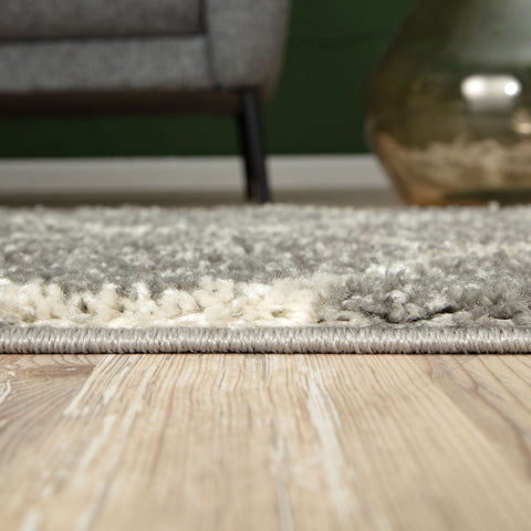 A plush moroccan grey shaggy rug with two-toned gray and white textured pile and neatly finished edges