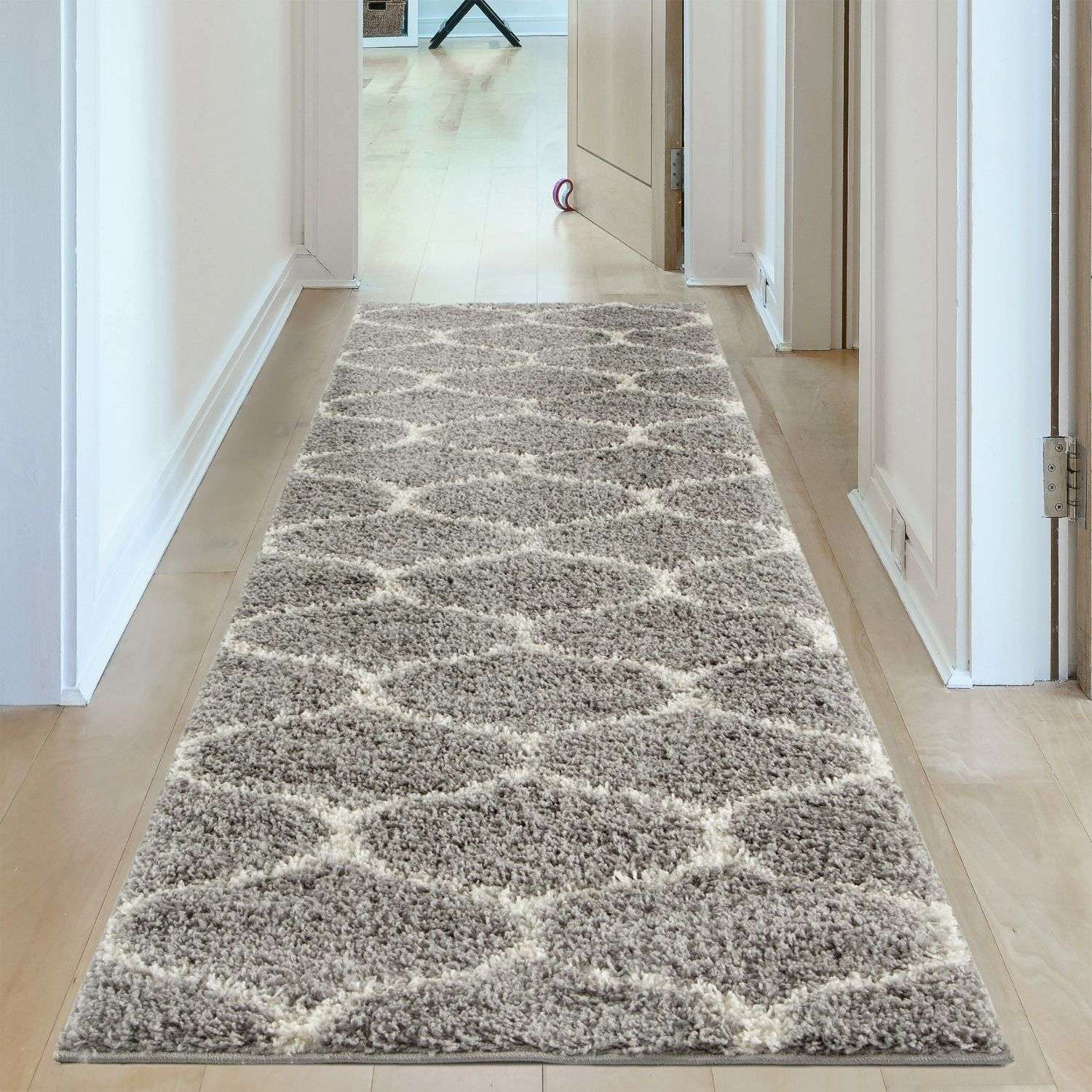 A plush moroccan grey shaggy hallway rug with cream geometric patterns and a soft textured pile