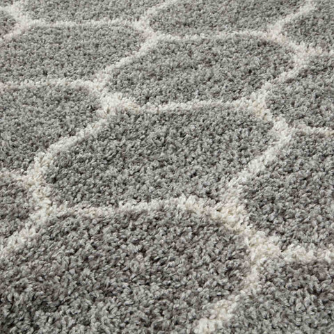 A plush moroccan grey shaggy rug with a soft textured surface and geometric grey and white pattern