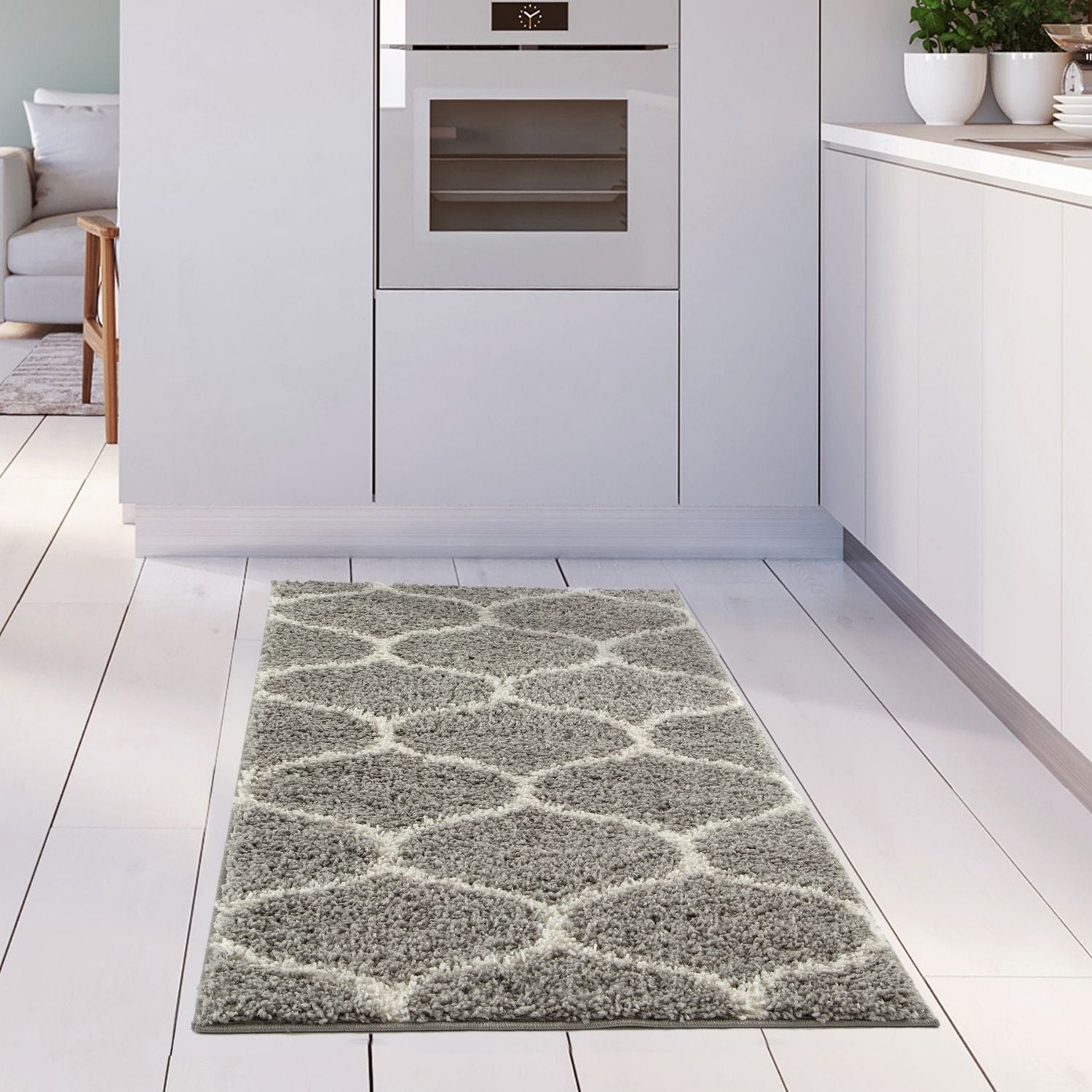 A plush moroccan grey shaggy kitchen rug with a soft texture and geometric grey and white pattern