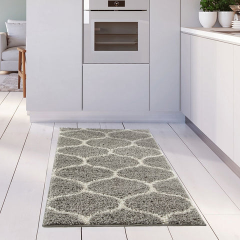 A plush moroccan grey shaggy kitchen rug with a soft texture and geometric grey and white pattern