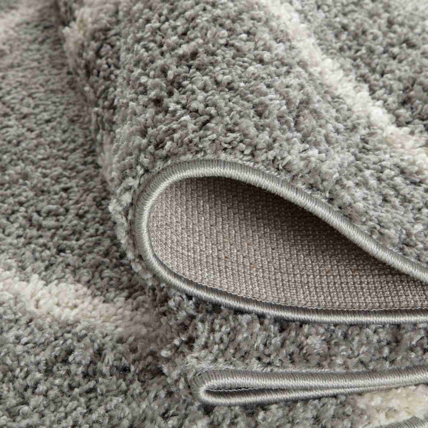A plush moroccan grey shaggy rug with soft textured surface and neatly finished edges perfect for cozy spaces