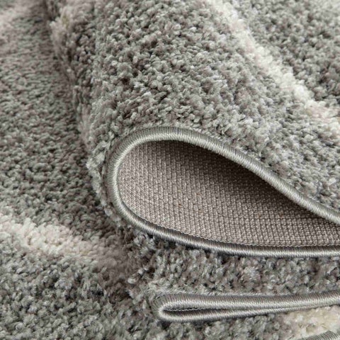 A plush moroccan grey shaggy rug with soft textured surface and neatly finished edges perfect for cozy spaces