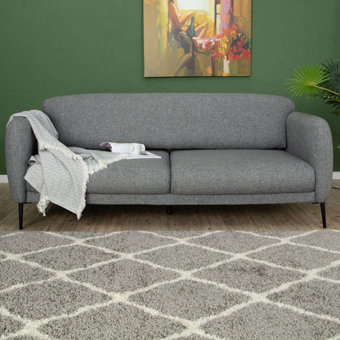 Gray textured fabric sofa with black legs and light gray throw near moroccan grey shaggy rug 710