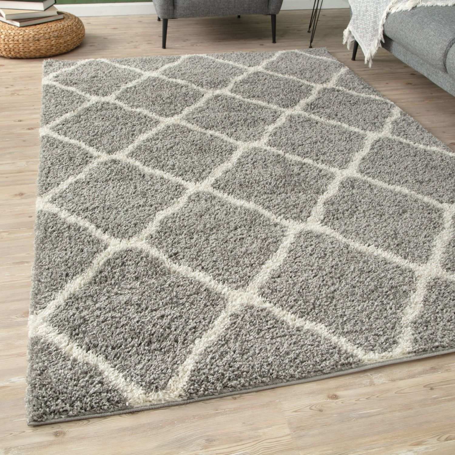 A moroccan grey shaggy area rug with a plush soft texture and geometric cream and gray pattern perfect for cozy spaces