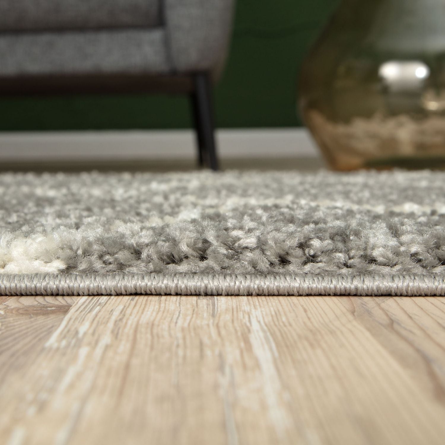 A plush moroccan grey shaggy rug with soft textured pile and neat edges on light wood flooring