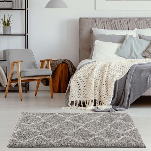 Moroccan grey shaggy rug with a geometric diamond pattern in lighter gray and white perfect for cozy spaces
